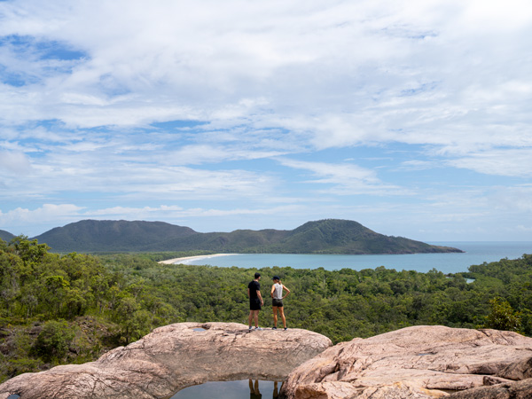 a couple standing on top of Hinchinbrook Island, Great Barrier Reef