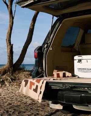 An esky in the back of a vehicle by the beach on tour with Kangaroo Island Touring Company.