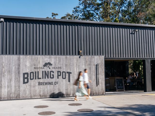 a couple walking outside Boiling Pot Brewing Co.