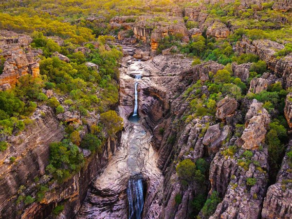 an aerial view of a waterfall in Kakadu