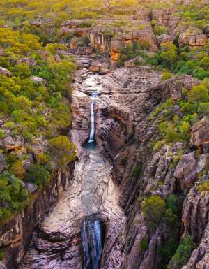 an aerial view of a waterfall in Kakadu