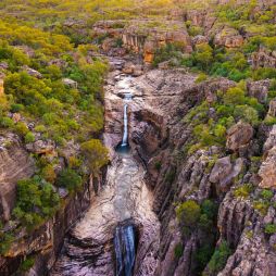 an aerial view of a waterfall in Kakadu