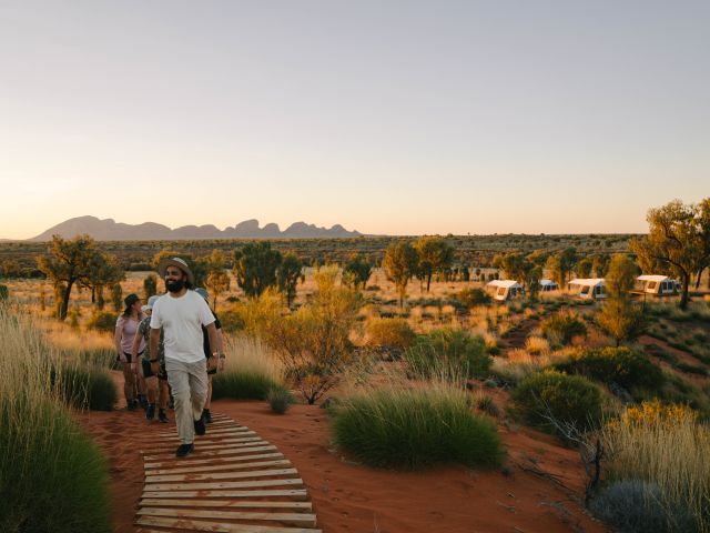 People walking with Kata Tjuta in the background