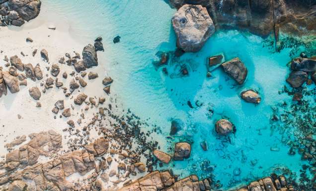 rocks dotting the clear blue waters of Boranup Beach