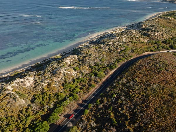 Aerial view of car alongside beach in the Margaret River Region
