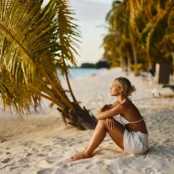 Woman deep in thought on an island beach