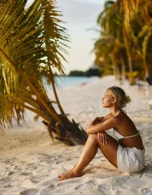 Woman deep in thought on an island beach