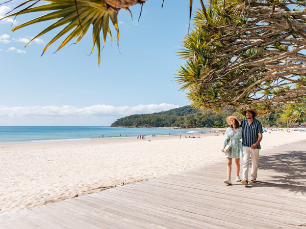 a couple walking on Noosa Main Beach