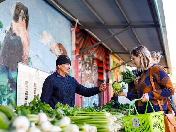 a woman buying fresh veggies at Perth City Farm