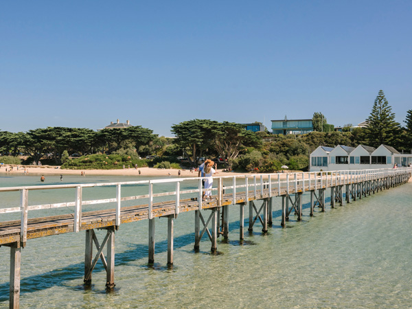 a couple walking along Sorrento Pier