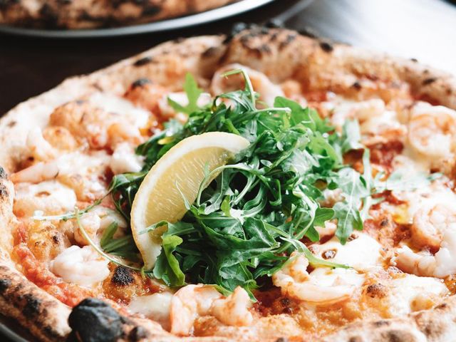 a close-up shot of pizza at Somedays Pizza, Noosa