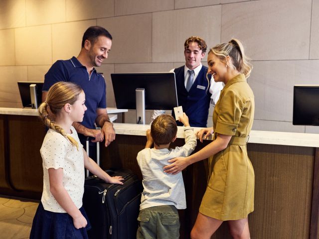 A family checking into the Hyatt Regency Sydney