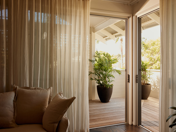 curtains slightly open letting the light in at 28 Degrees guesthouse in Byron Bay