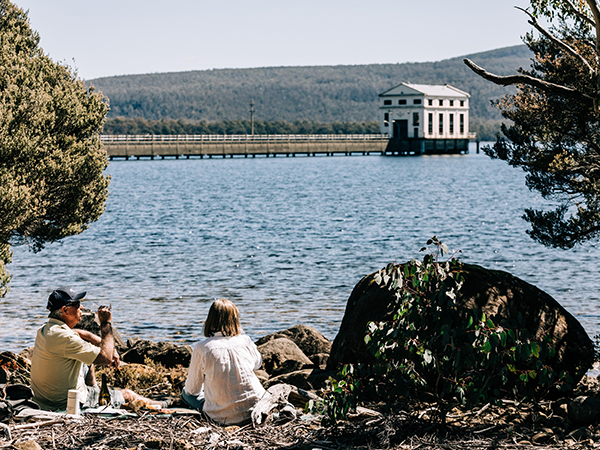 Two people having a picnic at Pumphouse Point.