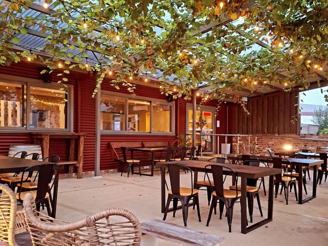 a tranquil and leafy seating area at Maitland Street Collective, Branxton