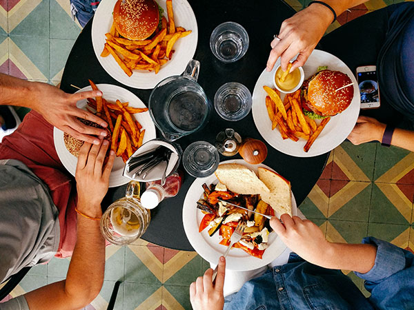 friends eating burgers around a table