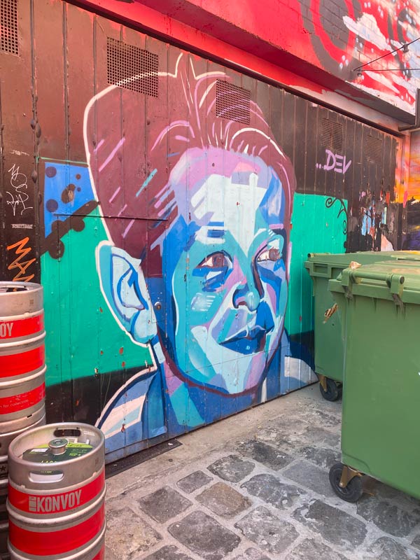 a colourful mural of a child on a wall in Fitzroy