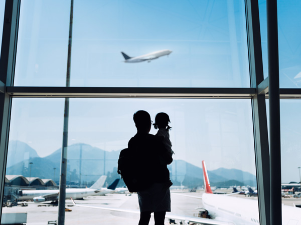 Stock images of a man and his child waiting at the airport