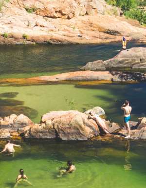 People swimming at Gunlom Falls in the Northern Territory
