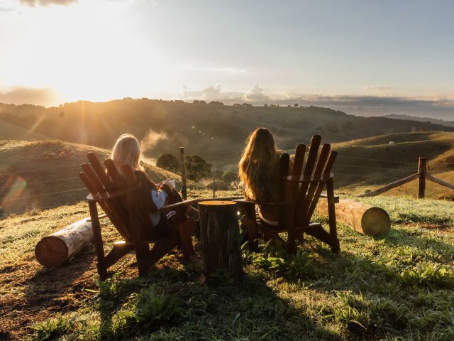 two people sitting on sun loungers while watching the sunrise at The Roost, Prevally WA