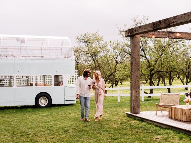 a couple wine tasting beside a double-decker bus at Down the Rabbit Hole, McLaren Vale wineries