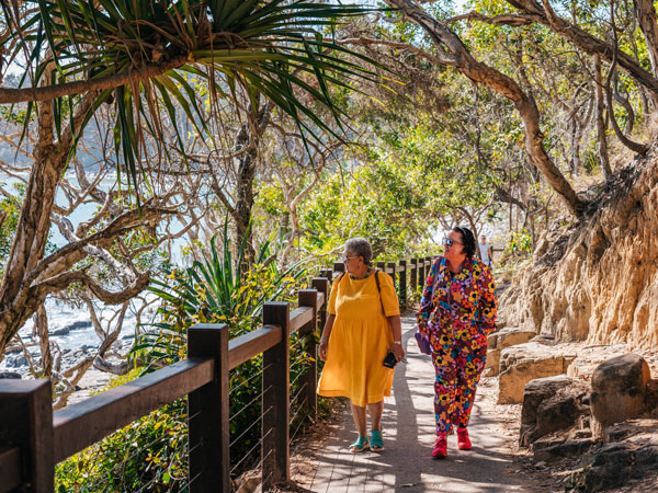 two women walking along the seaside boardwalk at Noosa National Park