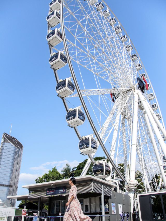 a woman walking along the Wheel of Brisbane