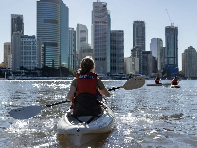 a woman kayaking on the Brisbane River