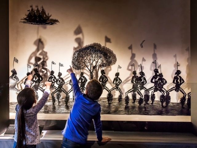 children admiring artworks at Bunjilaka Aboriginal Cultural Centre