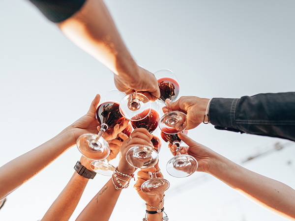 friends holding their wine in the air