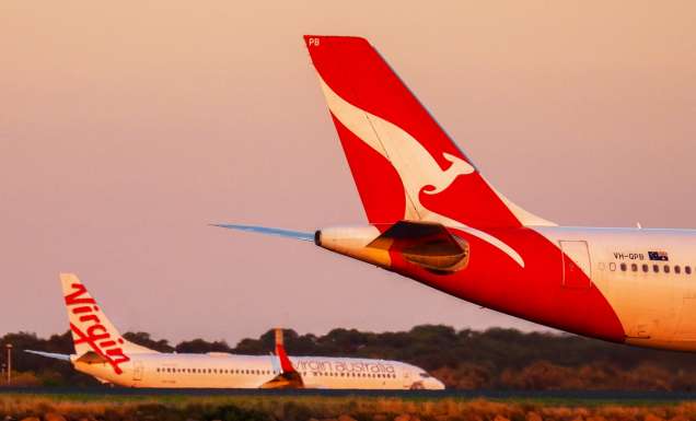 Qantas and Virgin planes on an airport runway