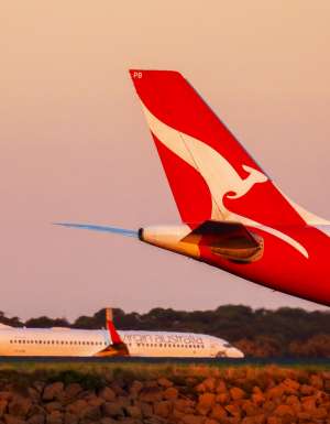 Qantas and Virgin planes on an airport runway