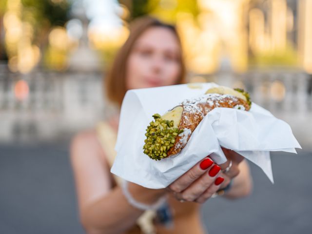 Woman holding a cannoli