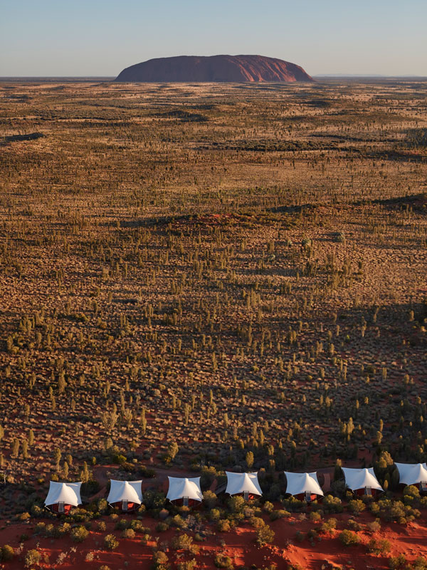 an aerial view of Uluru with Luxury lodge Longitude° safari-style tents