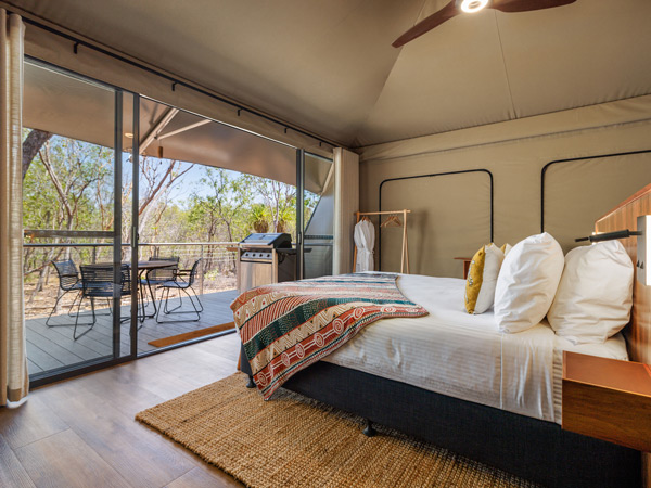 the bed in a luxe safari-style villa at Cooinda Lodge, Kakadu National Park