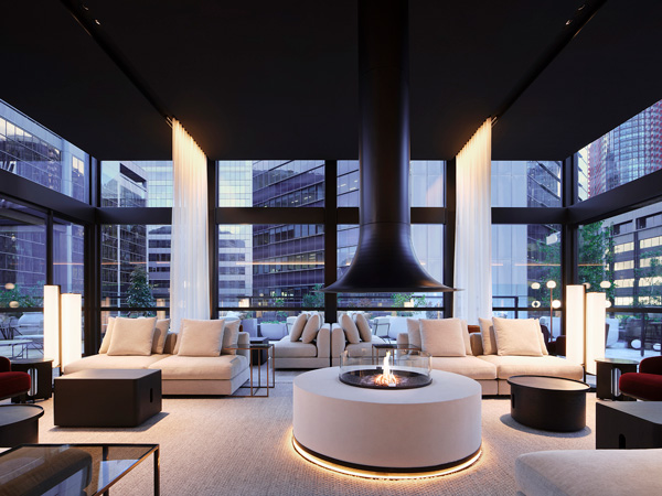 a modern living room with a fireplace at Little National Hotel Sydney