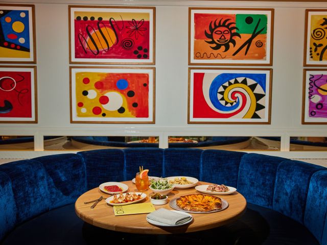 an Italian dining velvet blue booth at Pelicano