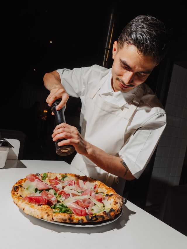a chef preparing a pizza at Modo Mio, Sydney