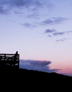 People watching the sun come up from a lookout