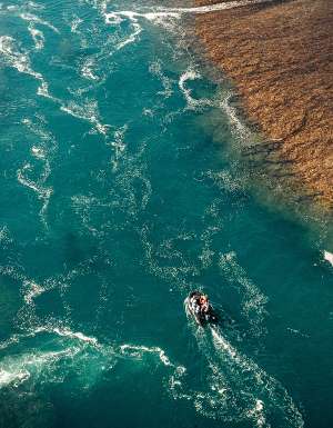 aerial view of boat going along Montgomery Reef
