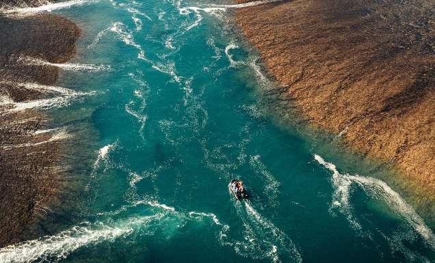 aerial view of boat going along Montgomery Reef