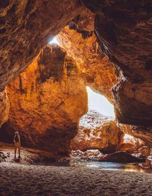 woman standing inside Dimalurru (Tunnel Creek) the kimberleys western australia