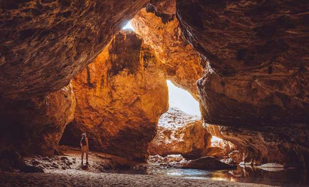 woman standing inside Dimalurru (Tunnel Creek) the kimberleys western australia