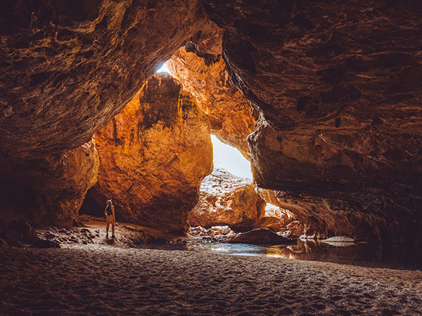 woman standing inside Dimalurru (Tunnel Creek) the kimberleys western australia