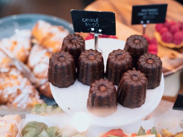 Dark and crisp canelés at Flour and Stone
