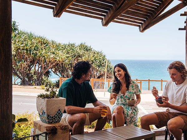 Group enjoying breakfast at the local cafe with ocean views