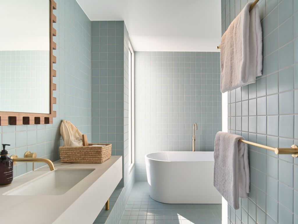 A bathroom at The Lodge Wadjemup with a freestanding bath
