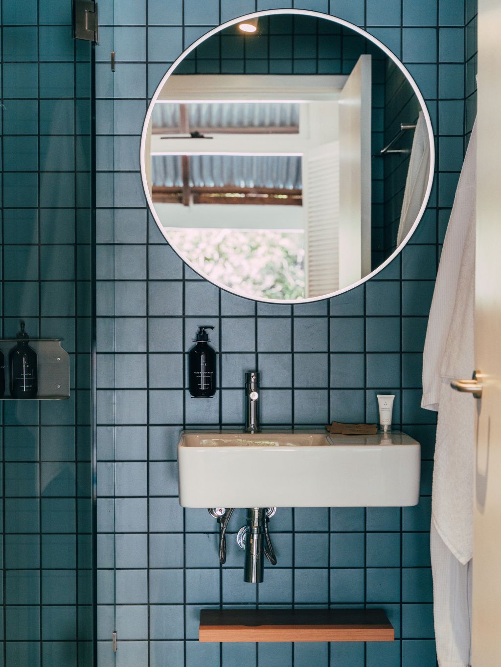 A bathroom with blue tiles at The Lodge Wadjemup