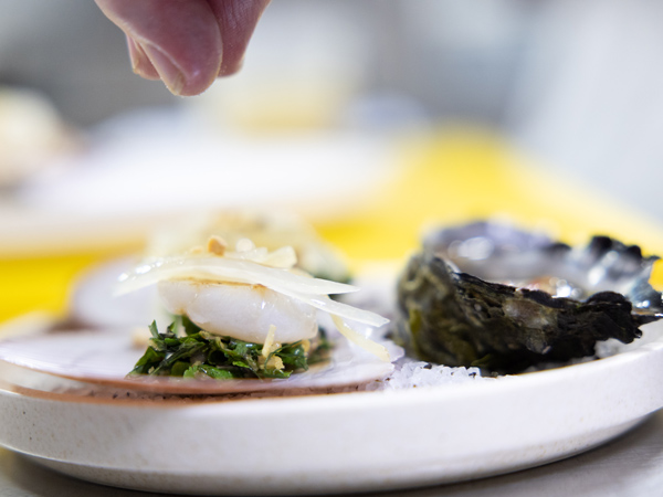Seasoning applied to grilled scallops and rock oysters
