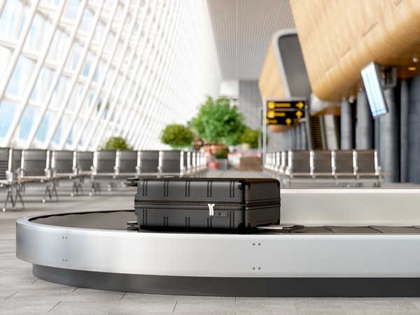 A suitcase on a buggage belt at the airport